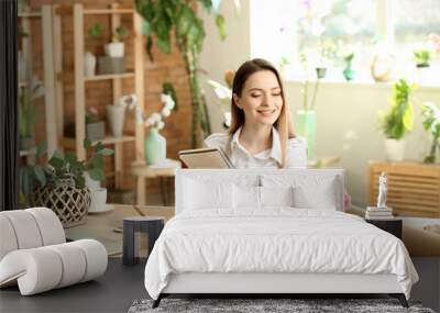 Young florist working in shop Wall mural