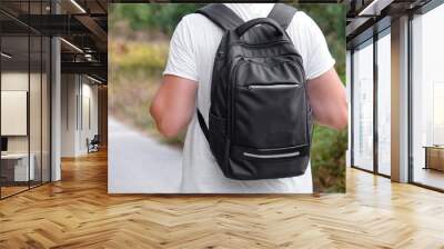 Young male traveler with modern backpack outdoors, back view Wall mural