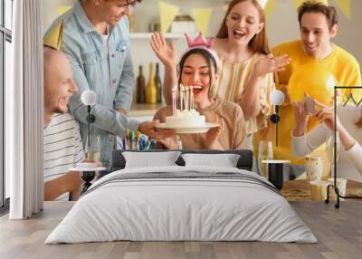 Young man bringing Birthday cake to his friend at party Wall mural