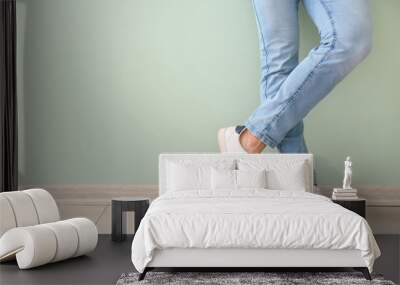 Young man in stylish shoes near color wall Wall mural