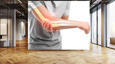 Young man suffering from pain in elbow on white background, closeup Wall mural