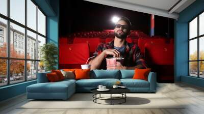 Young man watching movie in cinema Wall mural