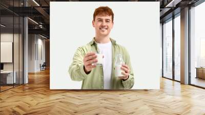 Young man with glass and bottle of milk on white background Wall mural