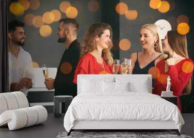 Young people clinking glasses of tasty champagne at party in office Wall mural