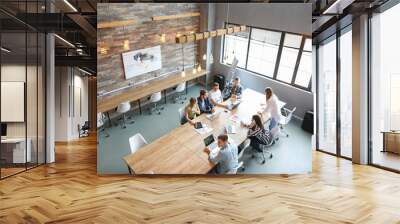 Young people having business meeting in modern office Wall mural