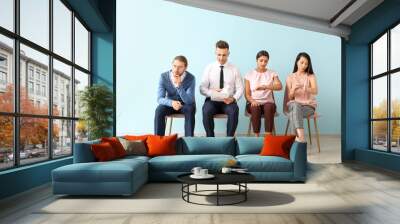 Young people waiting for job interview indoors Wall mural