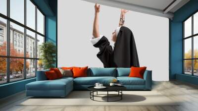 Young praying nun on light background Wall mural