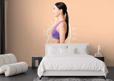 Young woman after weight loss on color background Wall mural