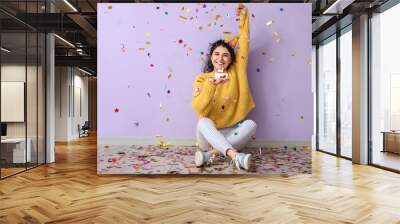 Young woman celebrating birthday on color background Wall mural