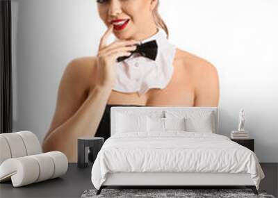 Young woman dressed as sexy waitress with cocktail on white background Wall mural