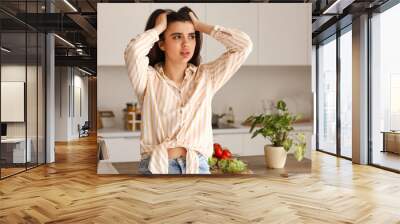 Young woman having panic attack in kitchen Wall mural