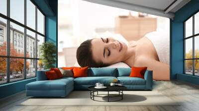 Young woman relaxing in spa salon Wall mural