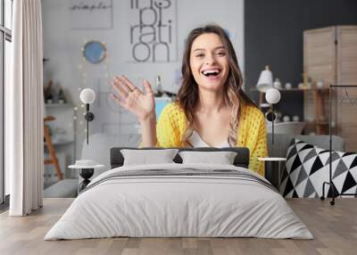 Young woman using video chat at home Wall mural