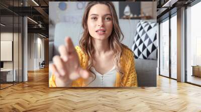 Young woman using video chat at home Wall mural