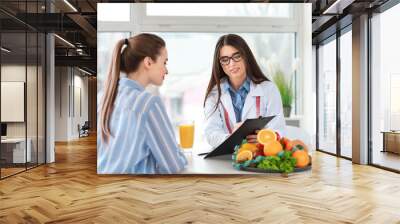 Young woman visiting nutritionist in weight loss clinic Wall mural