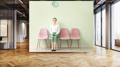 Young woman waiting for job interview indoors Wall mural