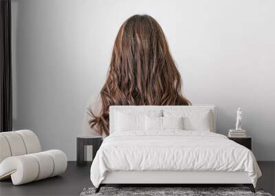 Young woman with beautiful hair on light background Wall mural