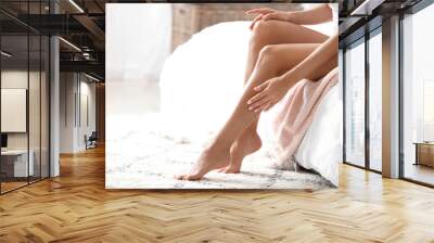 Young woman with beautiful legs in bedroom Wall mural