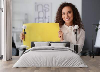 Young woman with blank paper sheet in office Wall mural