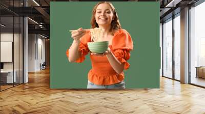 Young woman with bowl of Chinese noodles on green background Wall mural