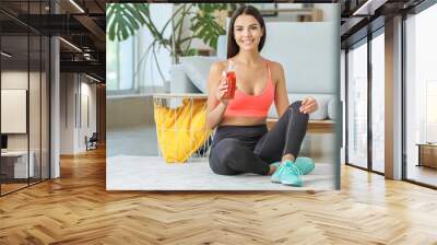 Young woman with healthy tomato juice at home Wall mural