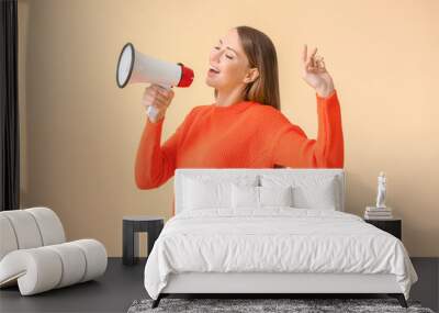 Young woman with megaphone on color background Wall mural