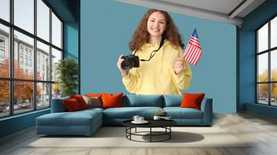 Young woman with USA flag and photo camera on blue background Wall mural