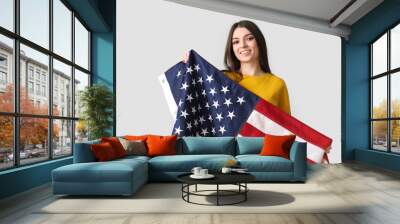 Young woman with USA flag on light background Wall mural