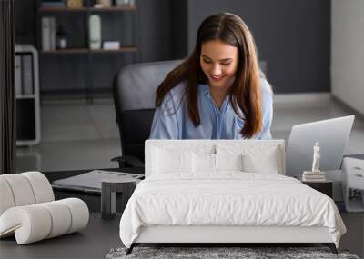 Young woman working with documents in office Wall mural