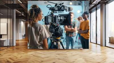 A behind-the-scenes look at a film set, showcasing a camera operator filming two actors. Wall mural