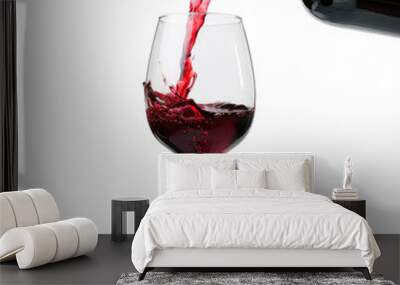  Pouring red wine in a glass isolated on white background  Wall mural