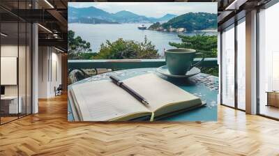 Travel Journal: An Open Journal with a Pen and a Cup of Coffee on a Table Overlooking a Scenic Vacation Spot Wall mural