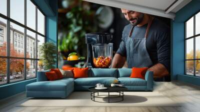 Man preparing fresh fruit smoothie in a modern kitchen filled with plants during the bright morning hours Wall mural