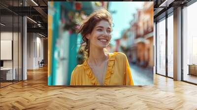 A smiling young woman in a cheerful yellow blouse, enjoying the vibrant downtown district Wall mural