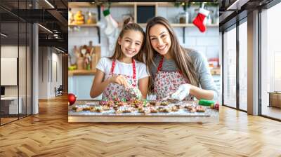 A happy light-skinned mother and her daughter, both wearing Christmas aprons, sharing the joy of baking and decorating cookies in a Christmas-themed kitchen. Wall mural