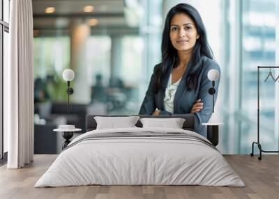 Professional headshot with a modern twist. a 45-year-old South Asian woman dressed in a sharp suit standing confidently in an elegant office setting Wall mural