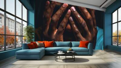 a black man crying is in a dark room with his hands over his eyes Wall mural