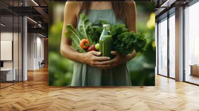 A mother presenting a blank green organic juice bottle near fresh green veggies Wall mural