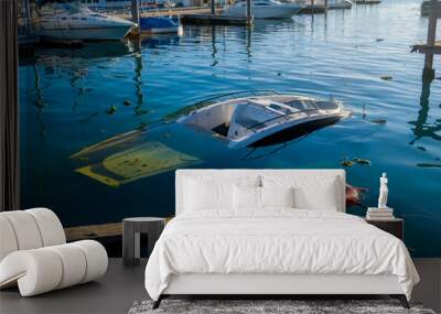 A boat crash scene in a quiet marina, with a partially submerged vessel and scattered debris floating in the still water, illuminated by early morning light. Wall mural