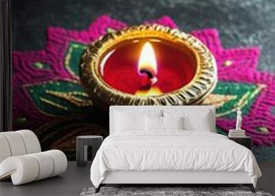 Low angle view, a single brass diya glowing atop a rich pink and green rangoli with swirling designs, resting on a dark grey surface, copy space, happy Diwali background, traditional, Indian  Wall mural