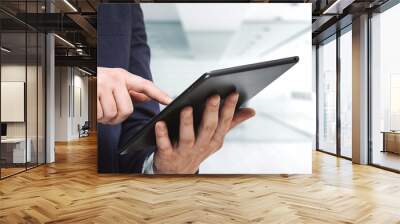 Businessman holds digital tablet and clicks on screen in modern office, close up. Search concept Wall mural