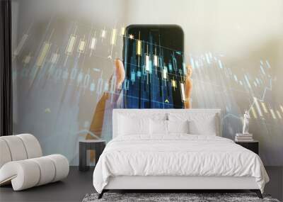 Double exposure of abstract creative financial chart and hand with cell phone on background, research and strategy concept Wall mural