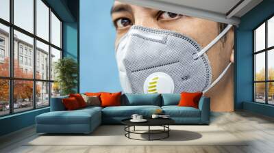 A man is wearing n95 mask for protect covid 19 and air pollution pm2.5 Wall mural