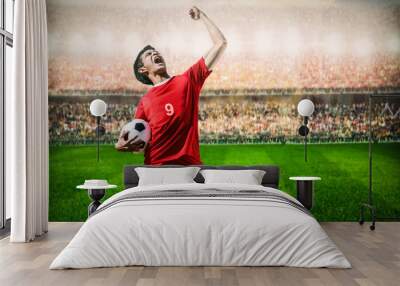 striker soccer football player in red team concept celebrating g Wall mural