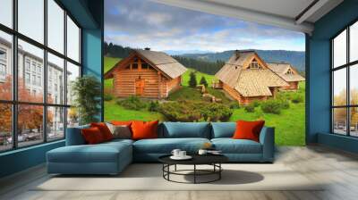 Ecological wooden houses on mounain hills Wall mural