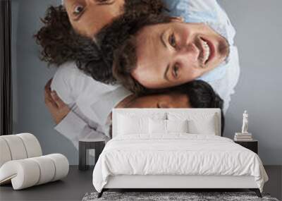 Three young people looking up Wall mural