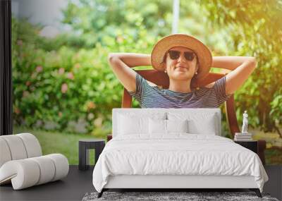 Young woman with book on knees Wall mural