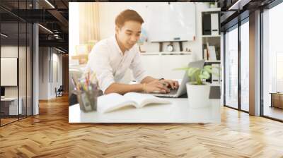 Asian young businessman working at his office. Wall mural