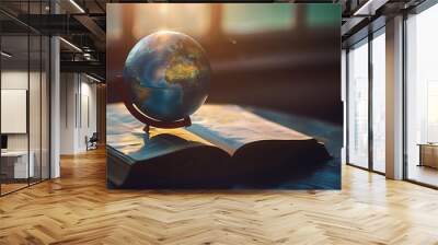 Visualize a striking image where a world globe is isolated atop round book pages, symbolizing knowledge and education on the International Day of Education Wall mural