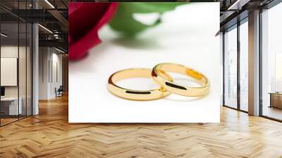 Wedding rings and artificial rose on white background Wall mural